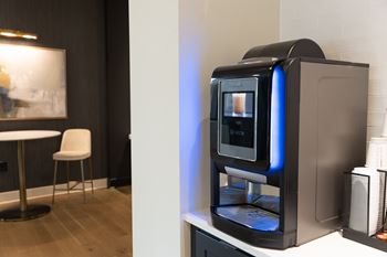 A modern kitchen with a coffee machine on the counter.